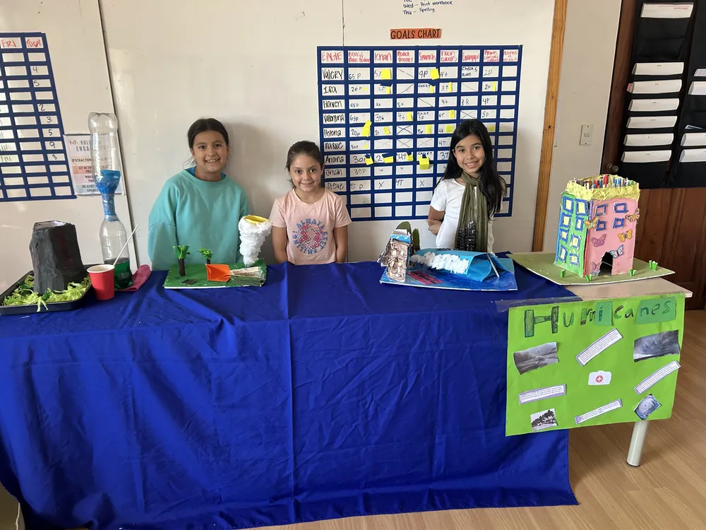 Learners presenting their own business project at a public exhibition at Acton Academy El Salvador