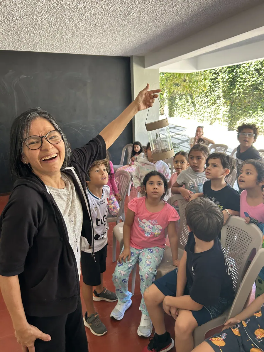 A guide laughing with her learners in a studio at Acton Academy El Salvador