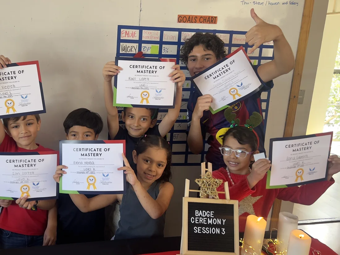 Learners at Acton Academy El Salvador holding their Certificates of Mastery at a badge ceremony